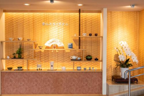 a shop with a yellow tiled wall with shelves at Unzen Sky Hotel in Unzen