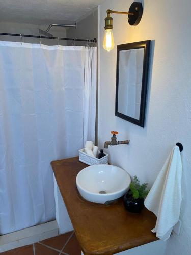 a bathroom with a white sink and a mirror at Casa Laberinto in San Miguel de Allende