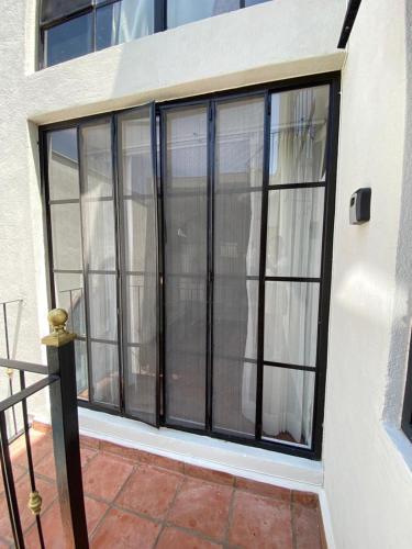 a large window with black frames on a building at Casa Laberinto in San Miguel de Allende