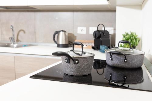 two pots on top of a stove in a kitchen at Monviso Exclusive Apartment in Milan