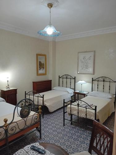 a room with three beds and a blue ceiling at Maison Manni' B&B in Soverato Marina