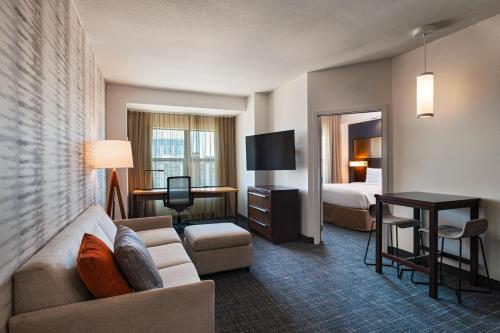 a hotel room with a couch and a bed at Residence Inn by Marriott Tempe Downtown/University in Tempe