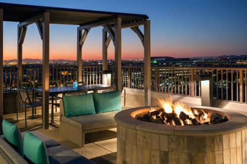 a fire pit on a deck with a table and chairs at Residence Inn by Marriott Tempe Downtown/University in Tempe