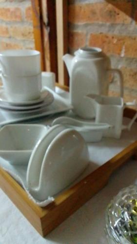 a tray with plates and cups and a tea set at Dublin in Rocha