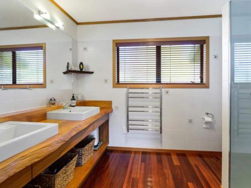 a bathroom with two sinks and a shower at The Terrace Lake Tarawera in Lake Tarawera
