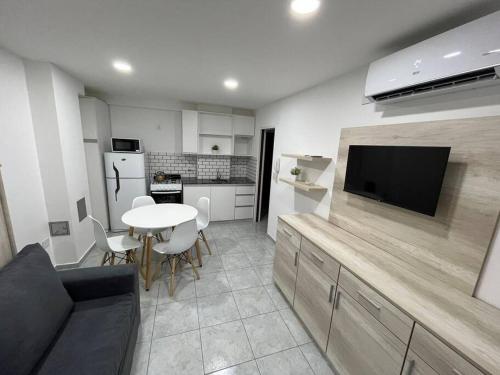 a kitchen with a table and a tv in a room at Departamento céntrico-46 n 326 entre1y2 in La Plata