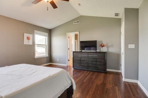 a bedroom with a bed and a flat screen tv at Indianapolis Home with Patio and Community Pool! in Indianapolis