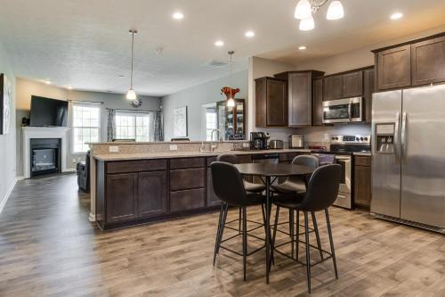 a kitchen with wooden cabinets and a table and chairs at Plainfield Vacation Rental about 13 Mi to Indianapolis in Plainfield