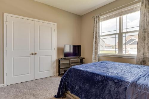 a bedroom with a bed and a tv and a window at Cozy Cartersburg Home about 14 Mi to Indianapolis in Cartersburg