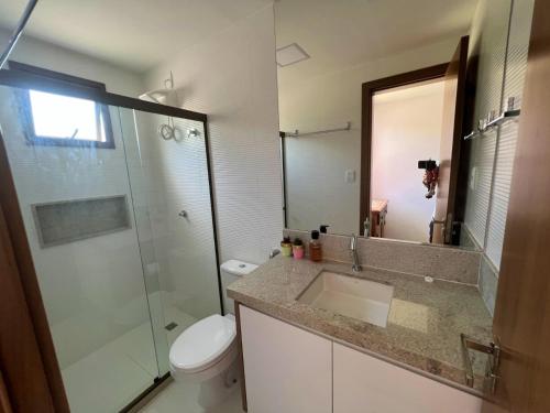 a bathroom with a sink and a toilet and a shower at Village Porto Feliz Itacimirim in Camaçari