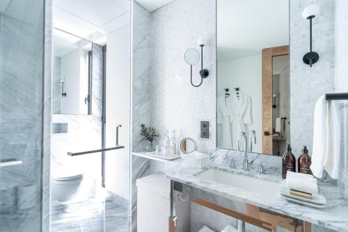 a white bathroom with a sink and a mirror at Casa Polanco Hotel Boutique in Mexico City