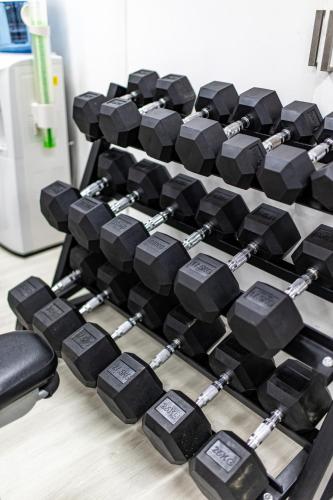 a pile of dumbbells on the floor of a gym at Seahaven Resort in Townsville