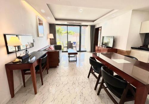 a living room with a table and chairs and a couch at Jeju Breeze in Seogwipo