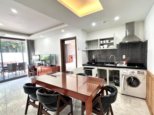 a kitchen with a wooden table and chairs in a room at Jeju Breeze in Seogwipo