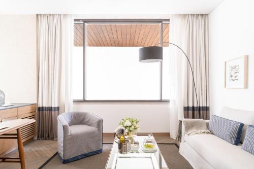 a living room with a couch and a chair at Casa Polanco Hotel Boutique in Mexico City
