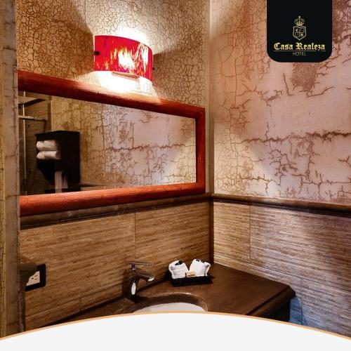 a bathroom with a sink and a mirror at Hotel Casa Realeza in Antigua Guatemala