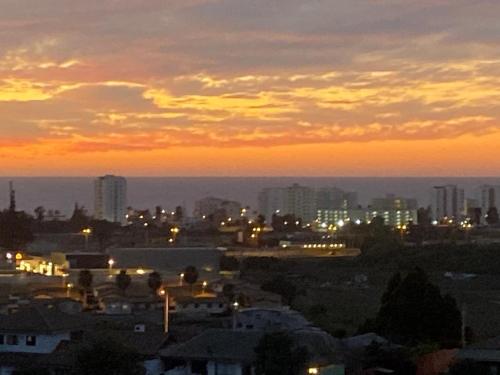a view of a city at sunset with buildings at Lindo departamento vista al mar in Coquimbo