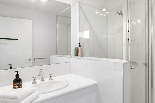 a white bathroom with a sink and a shower at Scelta in Lorne