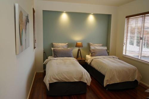 a bedroom with two beds and a window at Merrimont Downs in Merrijig
