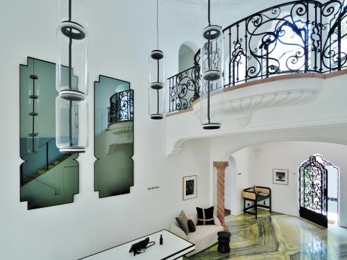 a living room with a staircase and chandelier at Casa Polanco Hotel Boutique in Mexico City