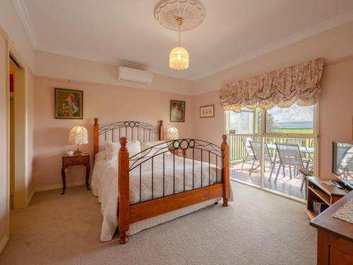 une chambre avec un lit et un balcon dans l'établissement Woodview Cottage Farm stay, à Port Welshpool