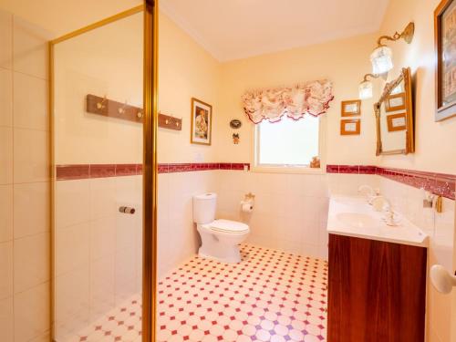a bathroom with a toilet and a sink at Woodview Cottage Farm stay in Port Welshpool
