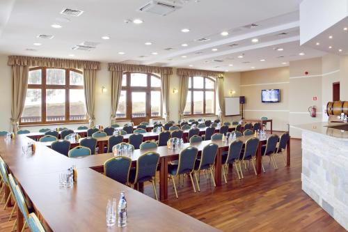 a conference room with a long table and chairs at Hotel Zieleniec in Zieleniec