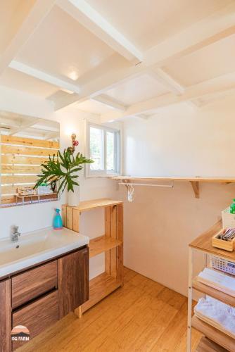 a large bathroom with a sink and a counter at Strawberry Guyabano Farm in Kabalen