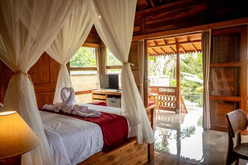 ein Schlafzimmer mit einem Bett in einem Zimmer mit einem Fenster in der Unterkunft Toya Sutra Villa in Tampaksiring