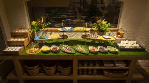 a table with many different types of food on it at Hotel Nishinagato Resort in Takibe
