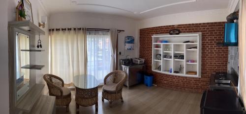 a dining room with a glass table and chairs at Raniban Suites - Studio Apartment in Kathmandu