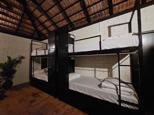 a room with three bunk beds in a building at beNomadic Eco Hostel, Madikeri, Coorg in Suntikoppa
