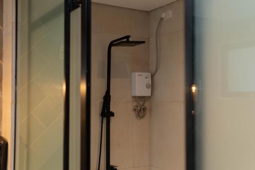 a shower in a bathroom with a shower at Adelina Hotel and Suites in Mati