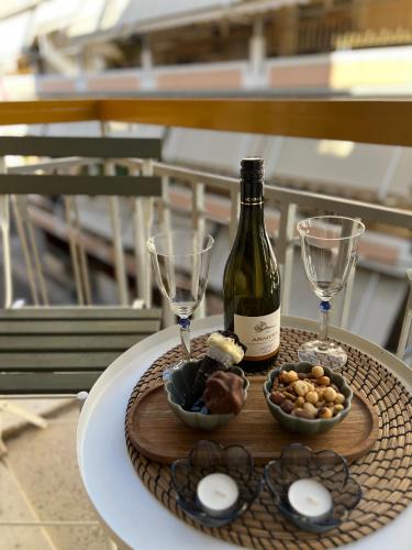 a table with a bottle of wine and two glasses at KK Athens Fine Stay-Steps to Metro-Modern & Cozy Apartments in Athens