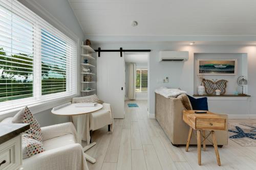 a living room with a couch and a table at Tides Inn on the Bay Vacation Homes in Bradenton Beach