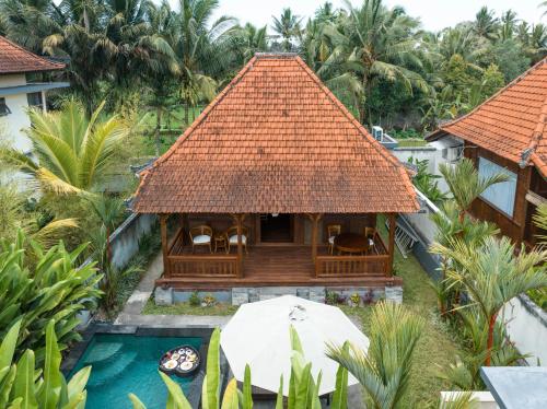 an aerial view of a resort with a pool and a house at Meng Bengil Villa in Ubud