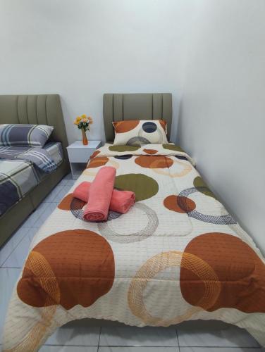 a bed with two pillows on it in a room at Ipoh Enchanted Sunway Ipoh Garden Home in Ipoh