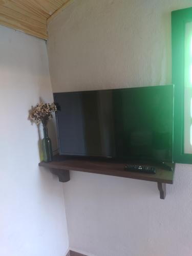 a flat screen tv hanging on a wall at Hospedaserra in Tiradentes