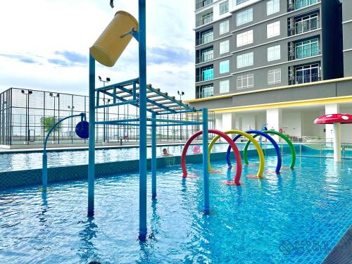 a pool with a water slide in a building at Melaka Novo 8 Residence - Jonker Street by Stayrene in Melaka