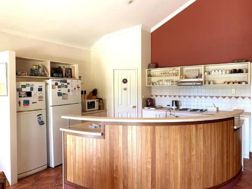a kitchen with a counter and a refrigerator at Rural Hideaway - Yallingup in Yallingup