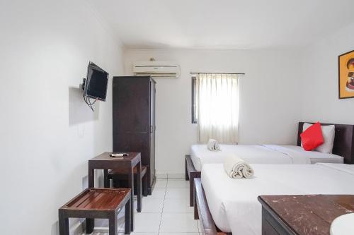 Postel nebo postele na pokoji v ubytování Gana Inn Legian