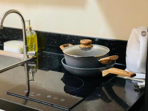 a pot sitting on top of a stove in a kitchen at Richjones Bed & Breakfast in Manila