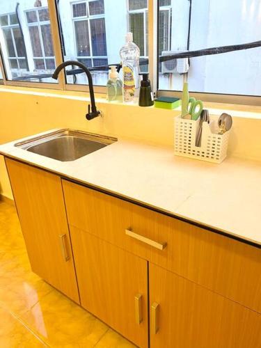 a kitchen counter with a sink and a window at 暖居Mersing Muji Cottage 0.3km Jeti Mersing Centre in Mersing