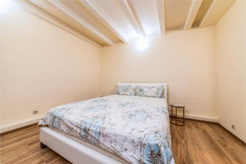a small bedroom with a bed in a room at Romana Boutique in Bucharest