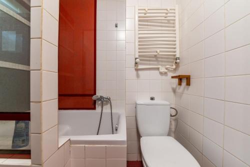 a bathroom with a toilet and a bath tub at Casa Romana in Bucharest