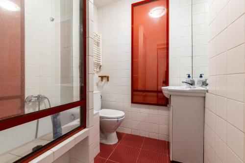 a bathroom with a toilet and a sink at Romana Boutique in Bucharest
