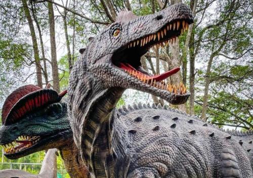 a statue of a dinosaur with its mouth open at Timurbay Seafront Residence & Suites in Kuantan
