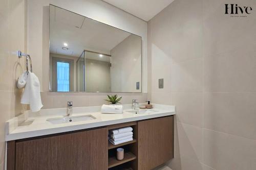 a bathroom with a sink and a large mirror at Ultra Modern 4 Bedroom Villa in Arabian Ranches 2 in Dubai