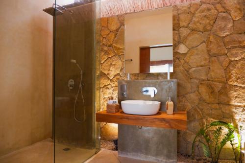 a bathroom with a sink and a shower at Reset Lombok Hotel in Kuta Lombok