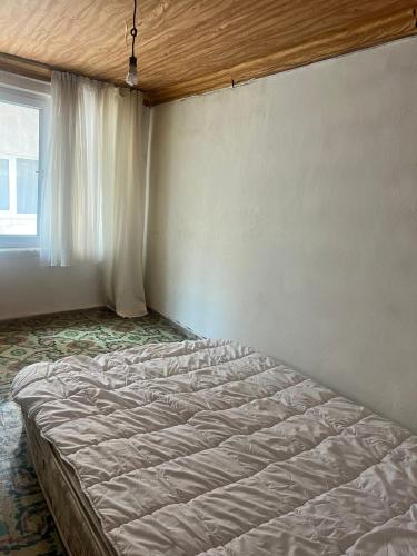 a large bed in a room with a window at Spacious House by the Sea in Gemlik